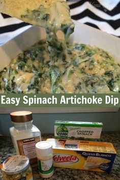 an easy spinach artichoke dip is being scooped from a casserole dish