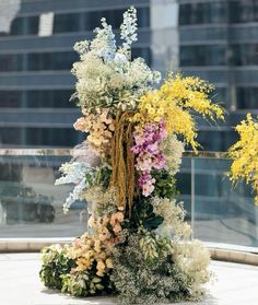 an arrangement of flowers on display in front of a building