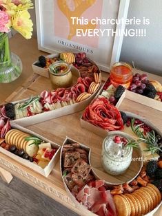 a table topped with different types of food and snacks on top of wooden trays