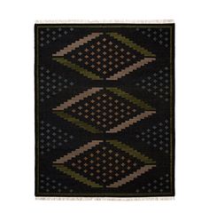 a black rug with green, brown and beige designs on the bottom half of it