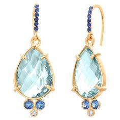 Add a touch of elegance and sophistication to your jewelry collection with these stunning 14 Karat Yellow Gold Hoop Drop Earrings. Crafted with exquisite attention to detail, these earrings are designed to make a statement with their luxurious blend of gemstones and timeless gold setting. Main Stone: Each earring showcases a pear-shaped blue topaz weighing a substantial 12 carats, offering a vibrant burst of sky-blue color. The faceted cut of the topaz creates an eye-catching brilliance, drawing Hoop Drop Earrings, Luxury Earrings, Yellow Gold Setting, Topaz Earrings, Jewelry Earrings Hoops, Gold Hoop, Jewelry Lover, Pear Shaped, Blue Topaz