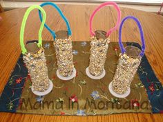 four pairs of shoes are on a mat with colorful rubber bands attached to the boots