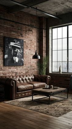 an industrial living room with brick walls and leather couches in front of a large window