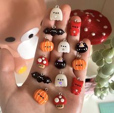 a hand with halloween themed charms on it