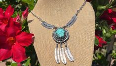 This beautiful turquoise and sterling feather necklace is in good vintage condition.  The turquoise is in good condition free of chips and cracks and is well set.  The necklace is secured with a circle spring clasp in good working condition.  The necklace hasn't been polished and has a nice even patina.  End to end the necklace measures 22 inches.  At the center it measures 2 3/4 inches from the top of the turquoise pendant to the tip of the feathers.  The three feathers are all free swinging.  It weighs 33 grams and is hallmarked E B, Sterling and the E is larger than the B.  I don't know who made this necklace. Turquoise Feather Jewelry As Gift, Turquoise Feather Jewelry As A Gift, Adjustable Turquoise Jewelry With Feathers, Bohemian Turquoise Jewelry With Feathers, Turquoise Bohemian Jewelry With Feathers, Dangle Necklace, Feather Necklace, Native American Turquoise, American Turquoise