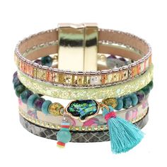 Madison Bohemian Multi-Strand Magnetic Bracelet Colors: Blue, Black, Green or Gray 6 Different Strands, each with a different design Charm: Hamsa Hand, Tassel Closure: Gold Magnetic Length: 19 cm (7.48 Inches) Width: 3.7 cm (1.45 Inches) Multicolor Bohemian Bracelet For Spring, Spring Bohemian Turquoise Jewelry, Bohemian Adjustable Bracelets For Spring, Spring Party Blue Bracelets, Bohemian Turquoise Bracelet For Party, Adjustable Turquoise Bracelets For Spring, Multicolor Leather Bracelet In Bohemian Style, Bohemian Bracelets For Summer Parties, Bohemian Beaded Bracelets For Party