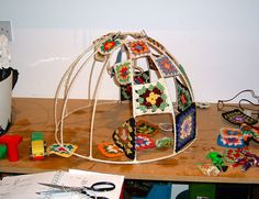 a wooden table topped with lots of crafting supplies and paper work on top of it