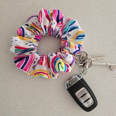 a colorful scrunffle keychain with a car key on it