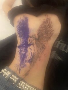 the back of a woman's stomach with an eagle painted on it