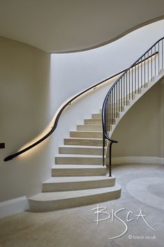 a spiral staircase in a house with white walls