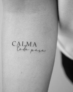 a woman's leg with the word calma written on her left calf sleeve