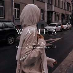 a woman walking down the street wearing a hijab