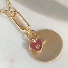 Quinn is the perfect necklace for your loving heart. It's a sweet petite pink enamel heart pendant on a long chain, so you can adjust the length based on your mood. Layer it with other jewelry to make a statement – then make it your own with personal charms. Jewelry To Make, Heart Disc, Loving Heart, Gold Disc, Disc Pendant, Pink Enamel, Gold Enamel, Long Chain, Cz Stone