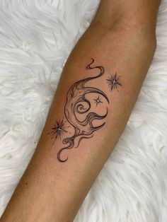 a woman's arm with a star and crescent tattoo on the left side of her leg