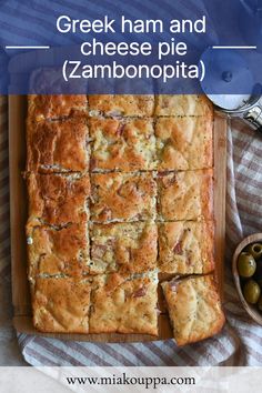 greek ham and cheese pie with olives on a cutting board