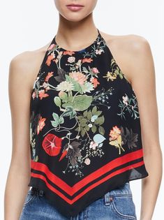 Embrace retro vibes with the Frenchie Handkerchief Halter Top from Alice + Olivia. This unique top features a halter neck, sleeveless design, and an open back with a playful tie closure. The exclusive-to-us print adds a touch of fun to any outfit. Perfectly paired with high-rise denim for a chic, '70s-inspired look. Details: Halter neck Sleeveless Open back with tie closure CC407P43012-H043 Materials: 100% Viscose Care: Dry clean only Chic Racerback Party Tops, Floral Print Halter Neck Top For Party, Spring Black High Neck Halter Top, Chic Sleeveless Halter Top For Summer, Black High Neck Halter Top For Spring, Chic Black High Neck Halter Top, Chic Sleeveless Floral Print Crop Top, Chic Halter Cami Top With Tie Back, High Neck Tank Top For Summer Nights Out