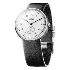 The BN0024 carries all of the hallmarks of the distinctive Braun design language. From the minimal dial face to the simple leather strap. This Braun Classic watch measures 38mm diameter x 8.5mm thick matt stainless steel case with a leather strap. It has a quartz 3 hand movement and a 50m water resistance with a scratch resistant mineral glass. Details: Case Diameter: 38mm Case Depth: 8.5mm Case Material: Stainless Steel Dial Colour: White Strap Width: 20mm Strap Material: Leather Strap Colour: Minimalist Leather Watch, Minimalist Leather Watch Accessories, Minimalist Leather Analog Watch, Minimalist Leather Watches With Subdials, Minimalist Leather Watch With Subdials, Minimalist Leather Watch Accessories For Business, Braun Watches, Braun Design, Simple Leather