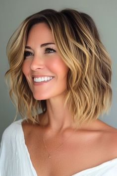 Save this pin for the best choppy bob hairstyles. Surf's up with this casual, choppy haircut! The tousled waves, caramel highlights, and choppy layers create a style perfect for summer (or whenever you want to feel like you're on vacation). Short Sandy Blonde Hair, Bob Hairstyles 2024 Trends, Medium Haircuts For Women Over 50, Choppy Bob Hairstyles For Thick Hair, Choppy Shoulder Length Hair, Bob Hairstyles Choppy, Bob With Texture, Medium Choppy Bob, Choppy Layered Bob Hairstyles