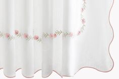 a white curtain with pink flowers on it