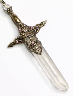 a cross shaped pendant with crystals on it