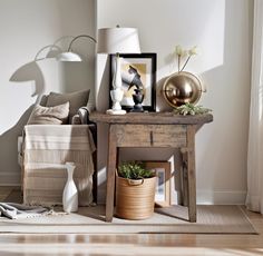 a living room with a couch, table and lamp