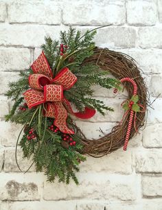 a christmas wreath hanging on a brick wall