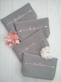 three gray bags with pink and white flowers on them, one has the word love written in cursive writing