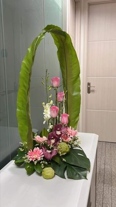 a flower arrangement is displayed on a table