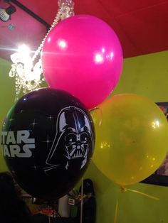 star wars balloons are hanging from the ceiling