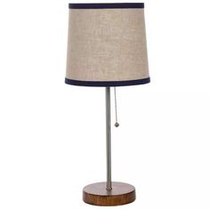 a lamp that is on top of a wooden base with a light shade over it