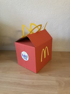 an open mcdonald's box on the floor