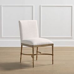 a white chair sitting on top of a hard wood floor