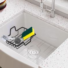 a kitchen sink filled with cleaning supplies on top of a counter