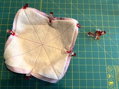 a piece of fabric sitting on top of a cutting board