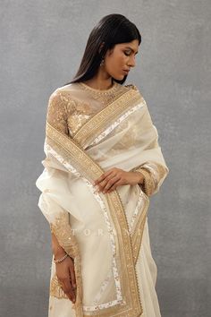 Ivory saree with floral placement print and dori, sequin embroidery in floral pattern.
Components: 1
Pattern: Printed, Embroidery
Type Of Work: Floral, dori, sequin
Fabric: Silk Organza, Cotton Silk, Butterfly Net
Color: Ivory
Other Details: 
Lace embroidered border
Tassel detailing on edges
Note: Blouse worn by the model is not for sale
Occasion: Wedding - Aza Fashions Ivory Saree, Saree Women, Silk Butterfly, Butterfly Net, Printed Embroidery, Placement Print, Embroidered Saree, Embroidered Border, Sequin Embroidery