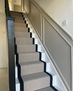 a staircase with carpeted steps leading up to the second floor