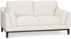 a white couch sitting on top of a wooden frame