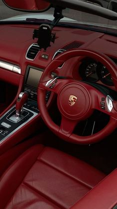 the interior of a car with red leather