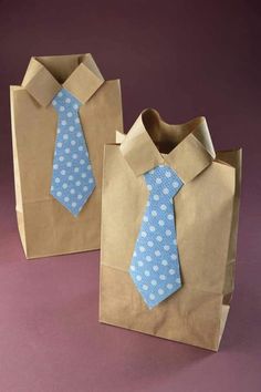 two brown paper bags with blue and white polka dots on them, one has a neck tie