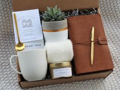 a gift box containing a mug, candle, and other items for someone's special occasion