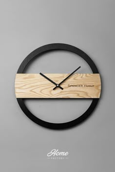 a clock made out of wood with the words spencer family on it's face