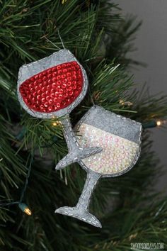 an ornament shaped like a wine glass hanging from a christmas tree