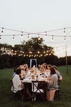 a group of people sitting around a dinner table