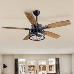 a ceiling fan with wooden blades in a living room