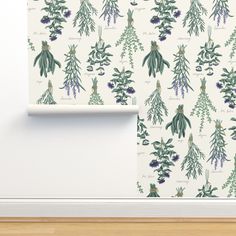 a wallpaper with green and purple leaves on it, next to a wooden floor