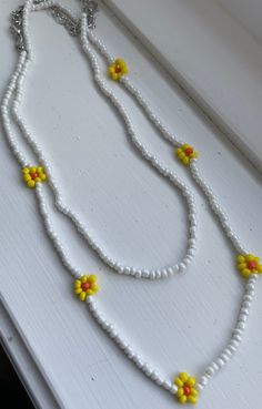 PAINTMOB PRESENTS: Trendy and beautiful minimalist 2 piece yellow and white flower necklaces for daily use. My necklaces can go with any clothing item and bring out any outfit/layering piece! Handmade jewelry with love and care from Canada. It is a perfect summer & spring accessory! CARE  The necklace is handmade by me and may vary a little from the photos. I do try my best to ensure durability, however, handling the jewelry with care is always a good idea to making them last. PRODUCTION TIMES A White Bohemian Beaded Necklaces For Spring, Adjustable White Jewelry With Flower Decoration, White Flower Necklace With Colorful Beads For Summer, White Summer Flower Necklace With Colorful Beads, Summer White Flower Necklace With Colorful Beads, Yellow Flower Necklace For Summer, Summer Yellow Flower Necklaces, Summer Yellow Flower Necklace, Yellow Round Bead Necklaces For Summer