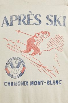 a white shirt with an image of a skier on it