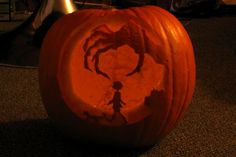 a carved pumpkin with the shape of a spider on it