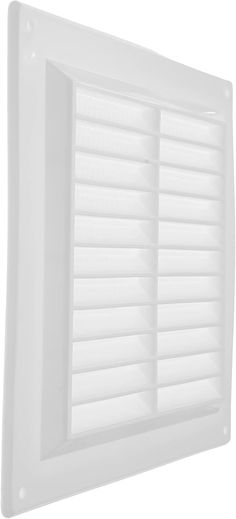 a white louvered window on the side of a wall