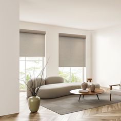 a modern living room with white walls and wood flooring, two couches in front of the window